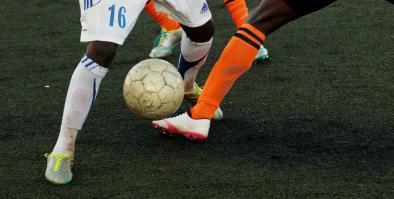 Two soccer players with soccer ball.