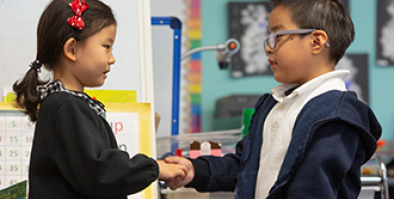 Two children shaking hands