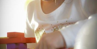 A child focusing on building with blocks