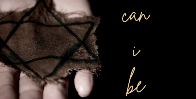 Hand holding a yellow Star of David made of cloth.
