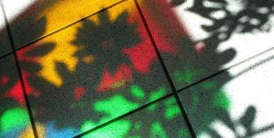 Photo by Peggy Reimchen, Attribution 2.0 Generic (CC BY 2.0) Trees, decorating the mall hallway, cast their shadow over colourful, translucent shadows caused when sunlight passes through plastic kites suspended from the Mall's vaulted skylight