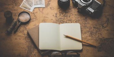 Notebook, pencil camera, magnifying glass