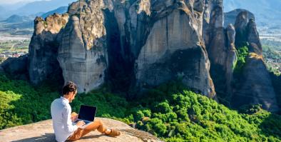 Business man on rock cliff